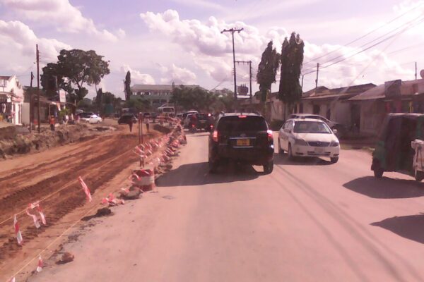 Road construction beside moving traffic at Sinza in Dar es Salaam, Tanzania