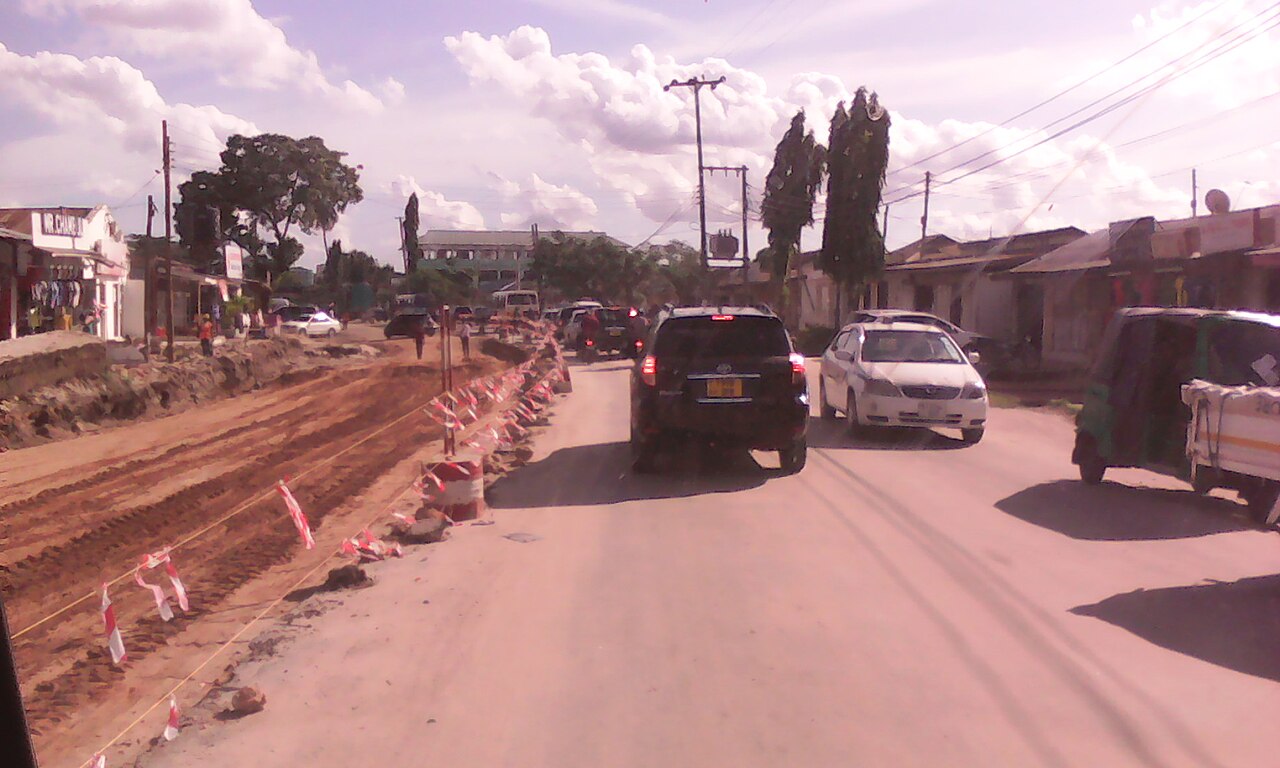 Road construction beside moving traffic at Sinza in Dar es Salaam, Tanzania