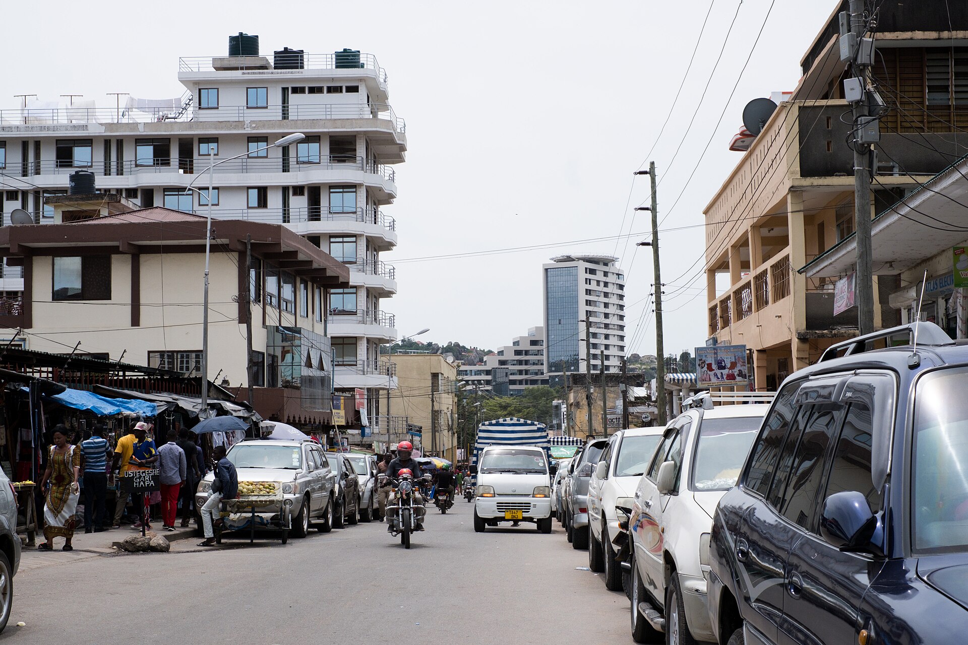 A busy street with shops and traffic in central Mwanza, Tanzania