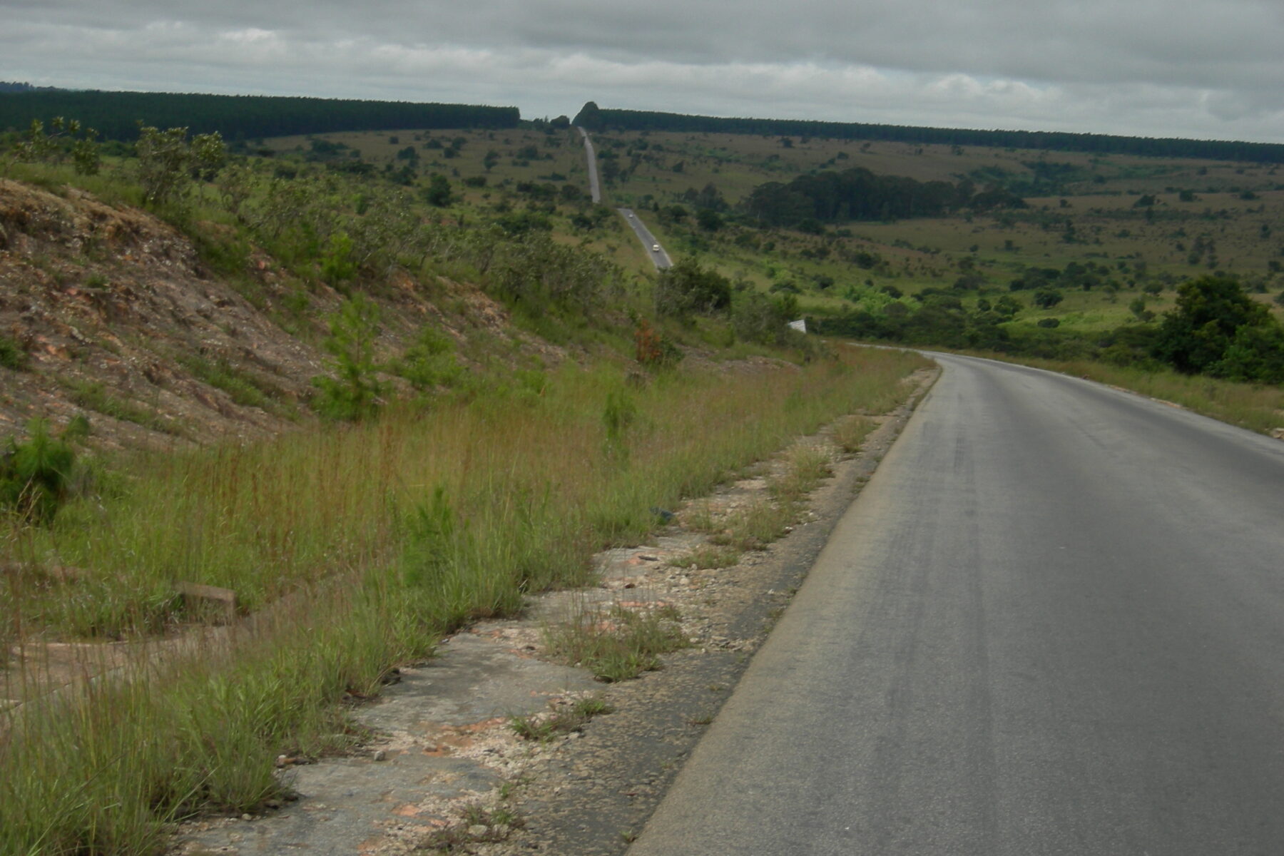 A paved road running through hills in Mbeya region, south-western Tanzania