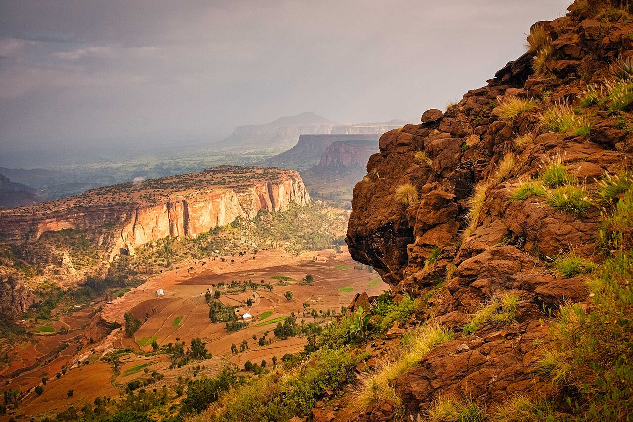 Red cliffs, terraced fields and a stormy sky in the highlands of Tigray, northern Ethiopia