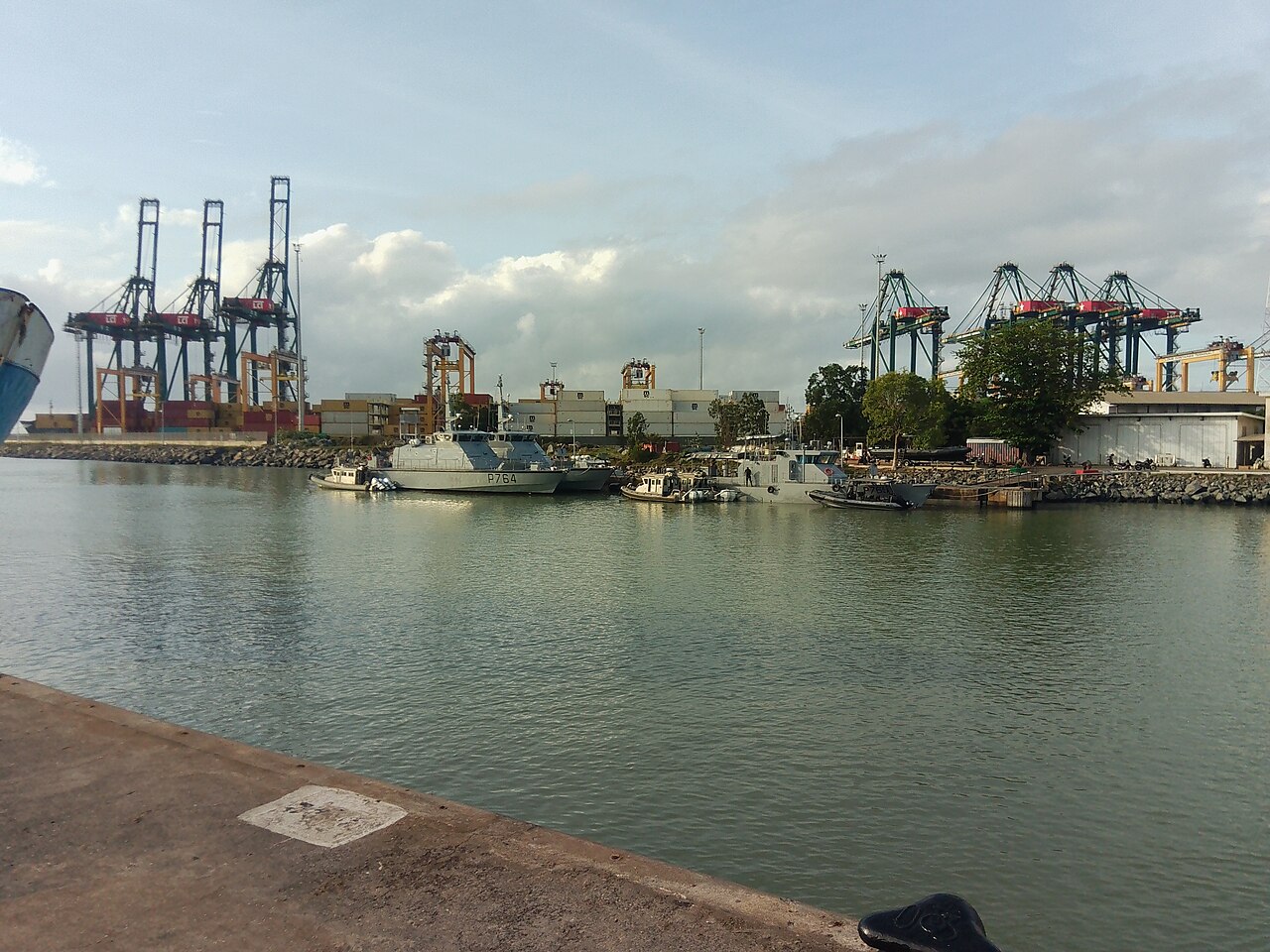 Patrol boats moored in the harbour of Lomé with container cranes on both banks