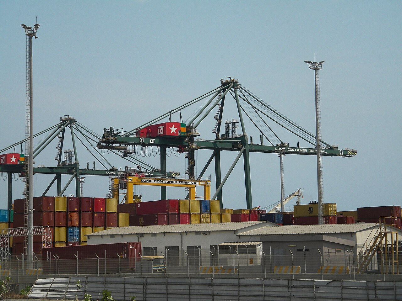 Gantry cranes marked Lome Container Terminal above stacked shipping containers
