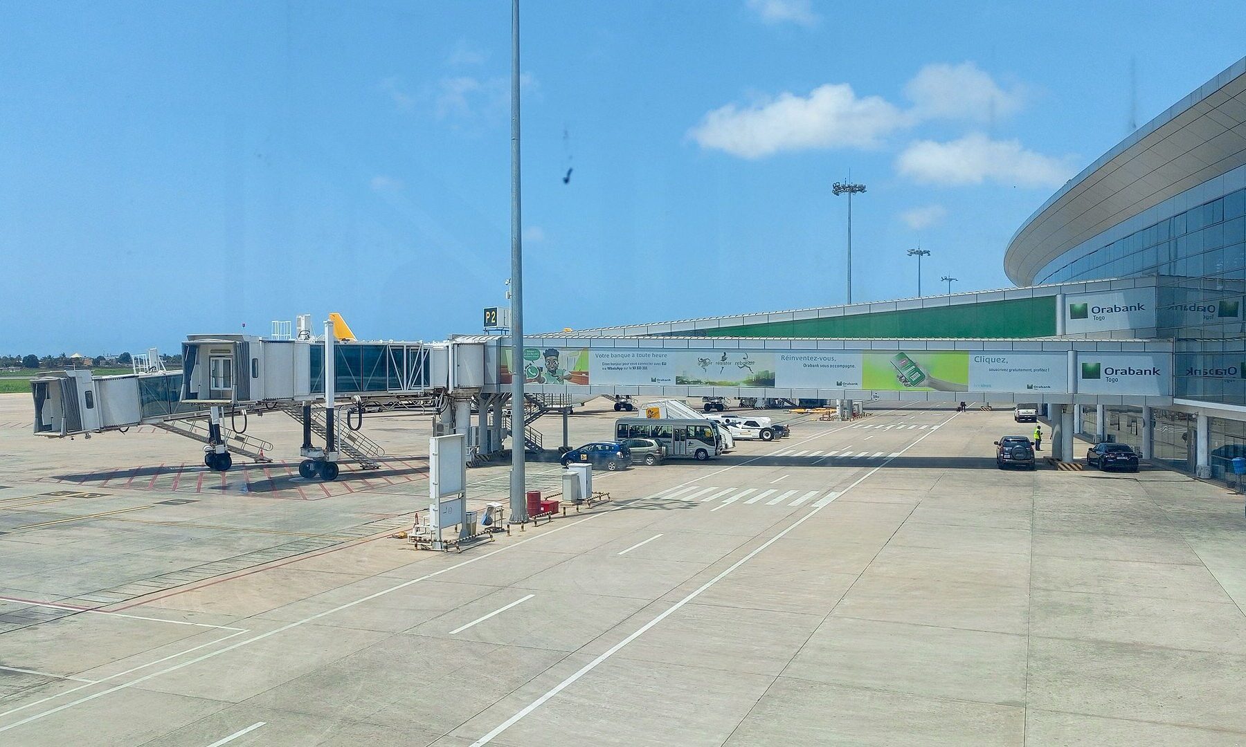 Passenger boarding bridges and the glass terminal at Gnassingbé Eyadéma International Airport in Lomé, Togo