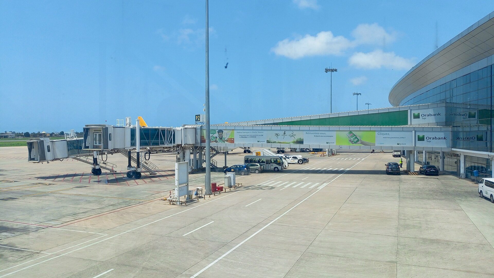 Passenger boarding bridges and the glass terminal at Gnassingbé Eyadéma International Airport in Lomé, Togo