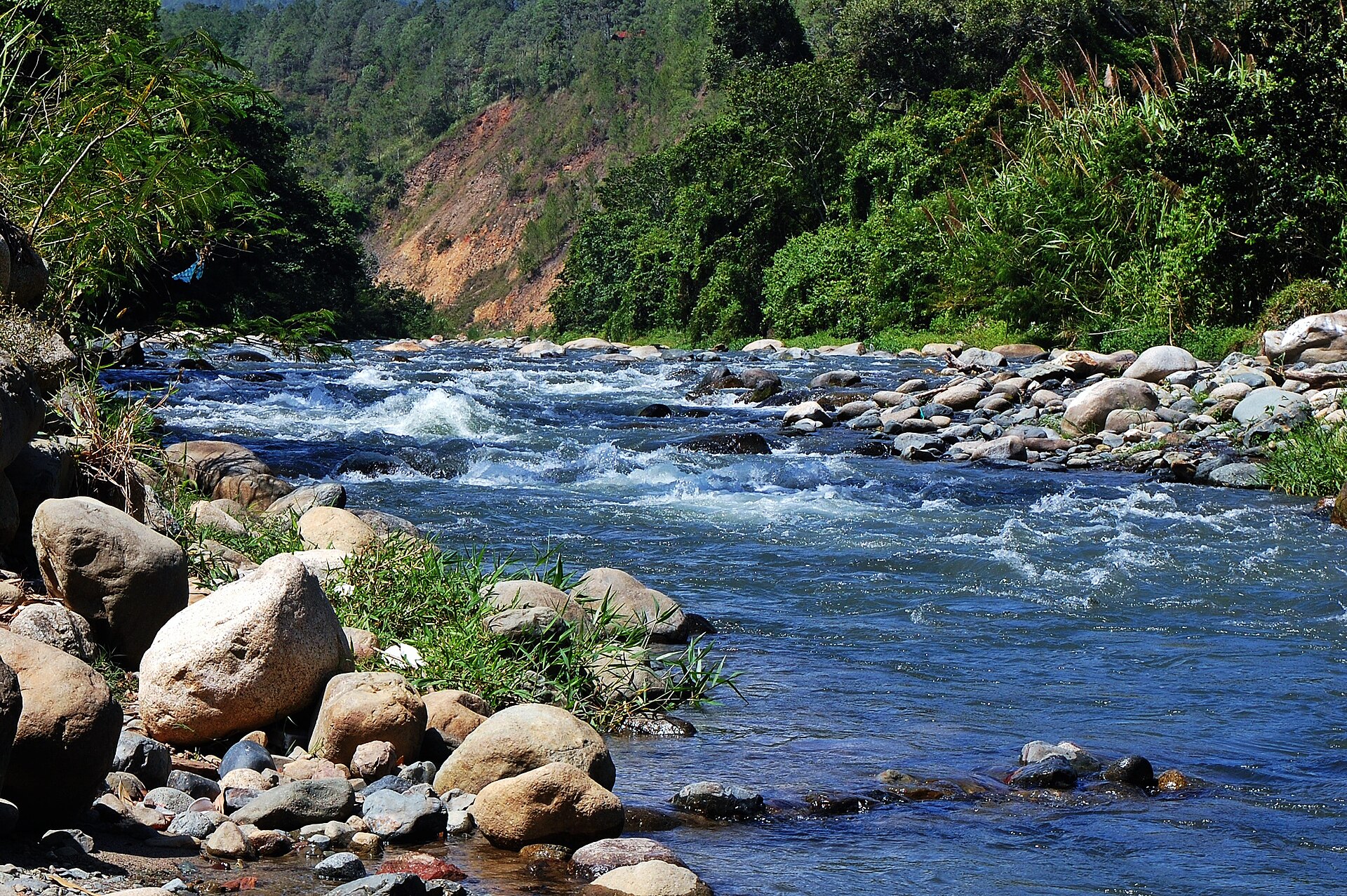 A rocky river running through forested mountains near Jarabacoa