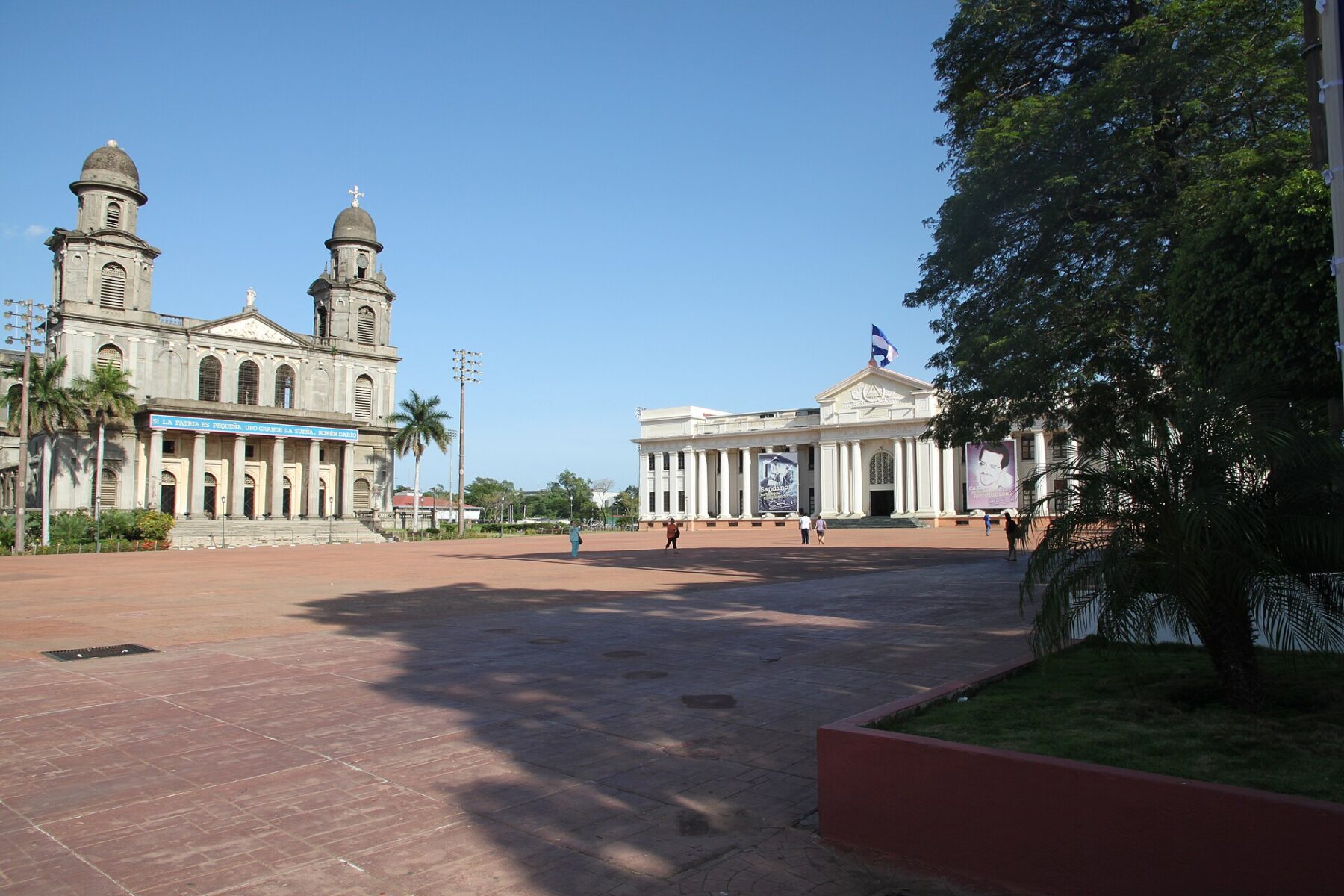 The Plaza de la Revolucion in Managua with the Old Cathedral on the left and the National Palace of Culture on the right under a clear blue sky