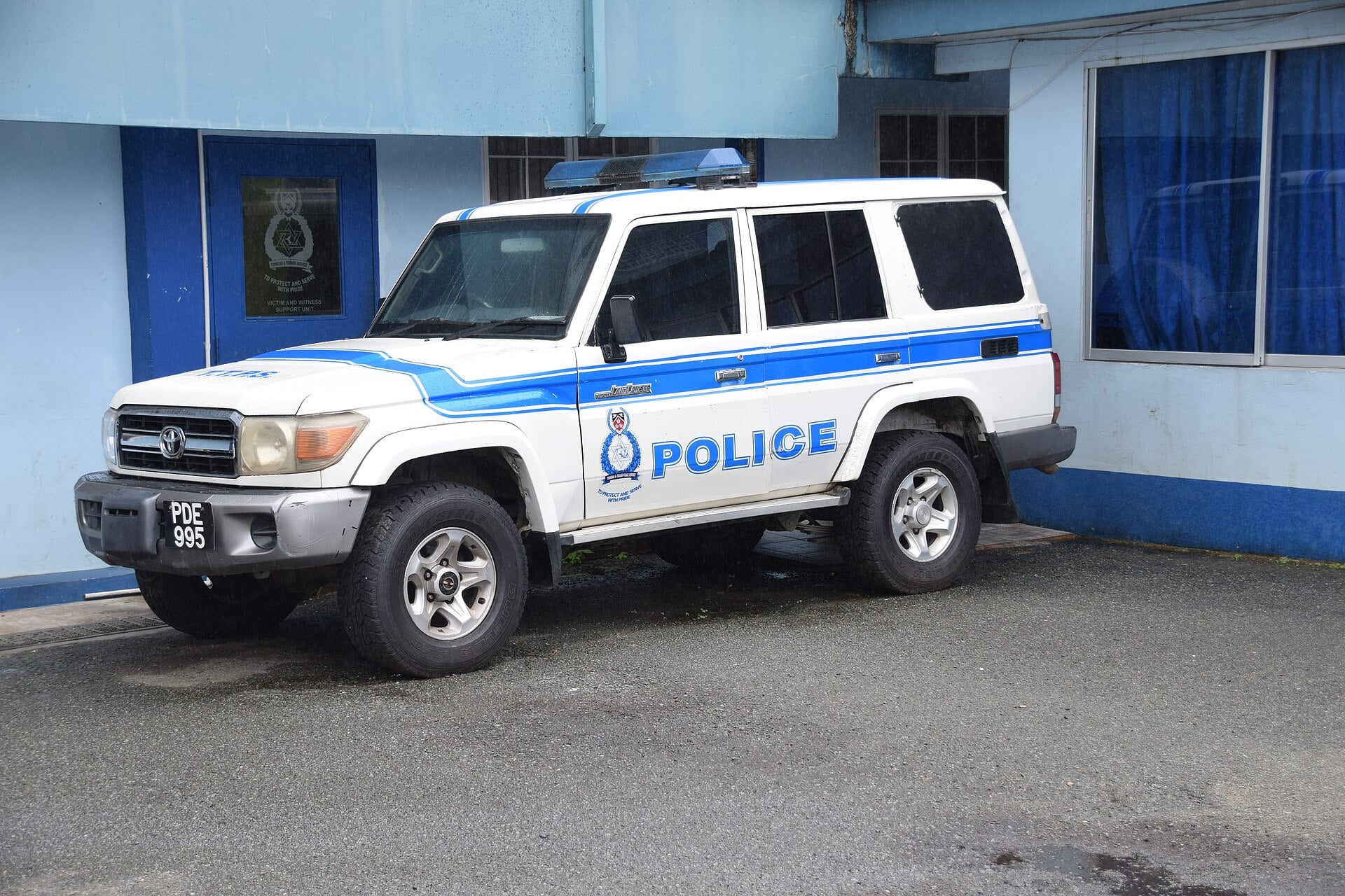 A Trinidad and Tobago Police Service Land Cruiser parked outside a police building in Tobago