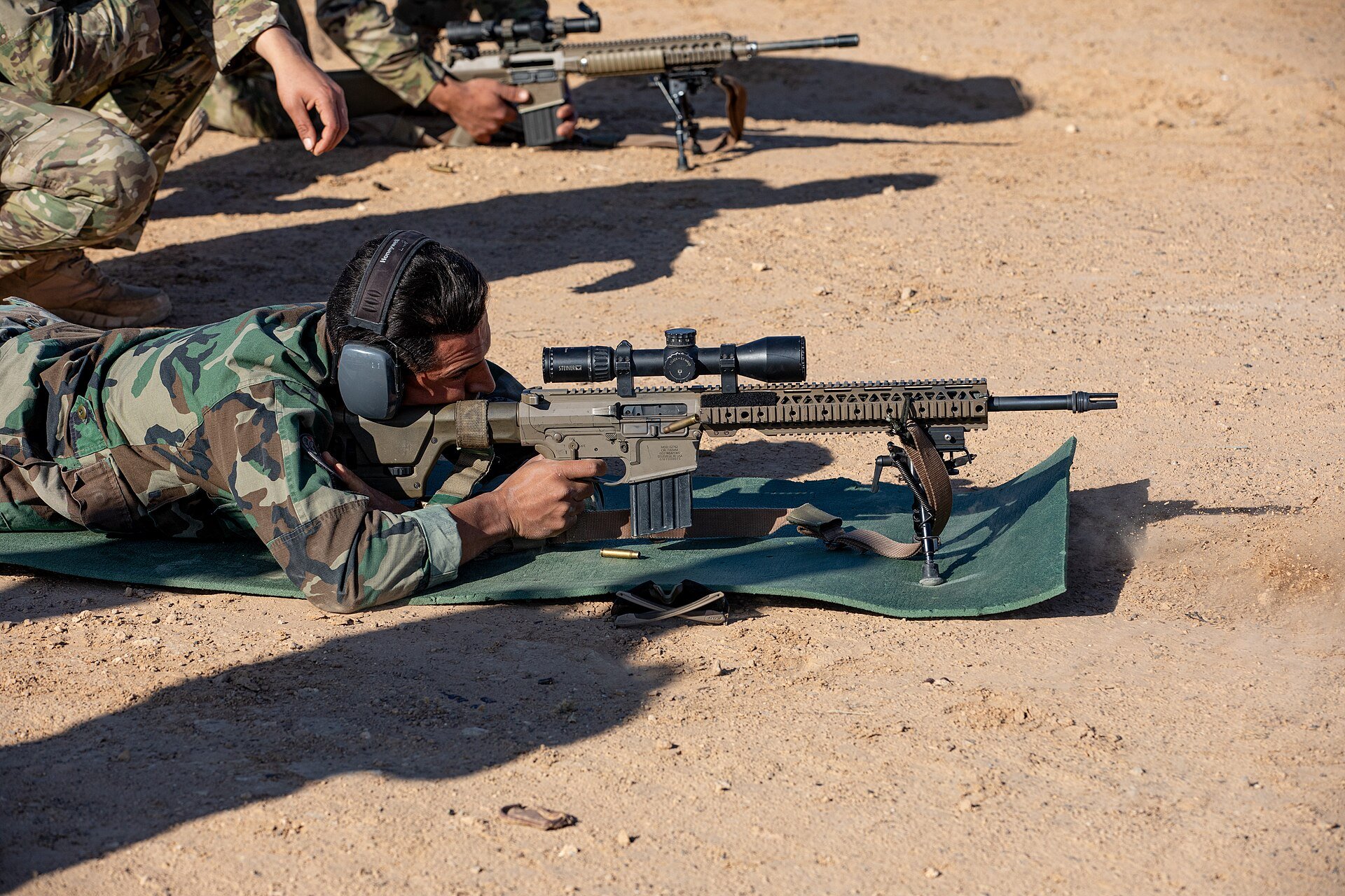 Tunisian Armed Forces soldier aiming a scoped rifle during sniper training in the African Lion 2025 exercise