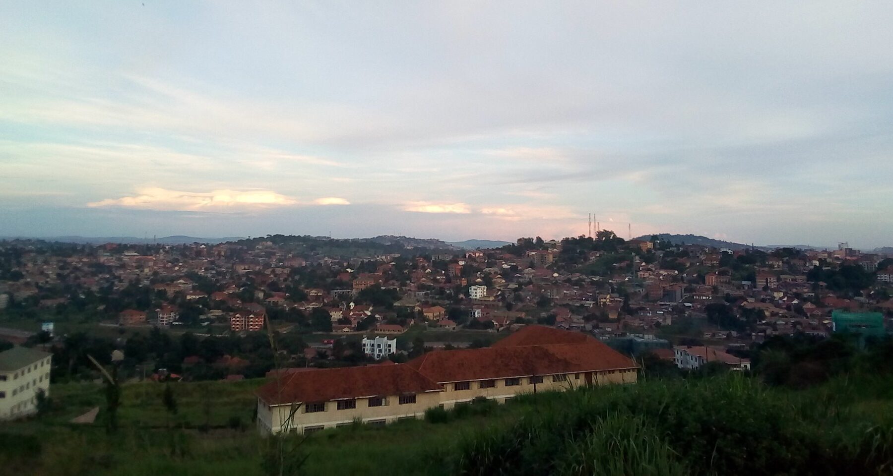 Residential hills of Kampala seen from Kisasi Hill, with telecom masts on the skyline