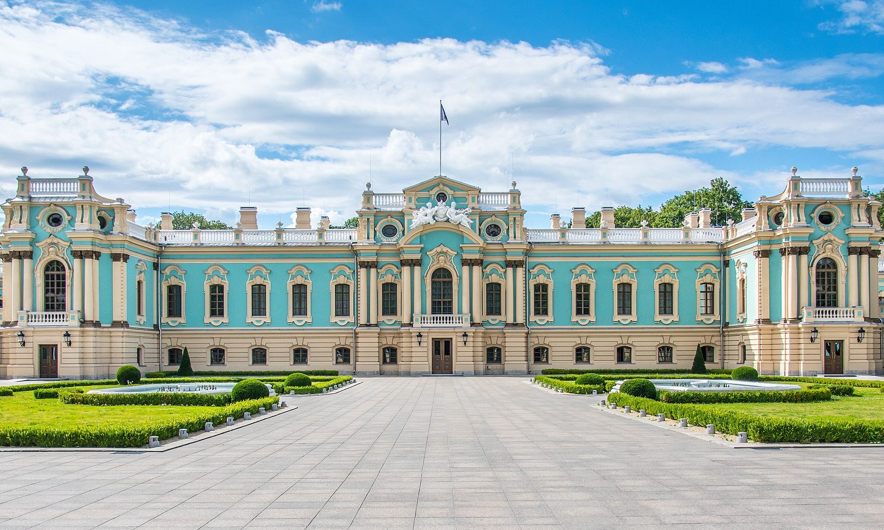 The Mariinskyi Palace in Kyiv, a blue-and-white baroque building with a formal garden in front