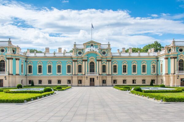 The Mariinskyi Palace in Kyiv, a blue-and-white baroque building with a formal garden in front