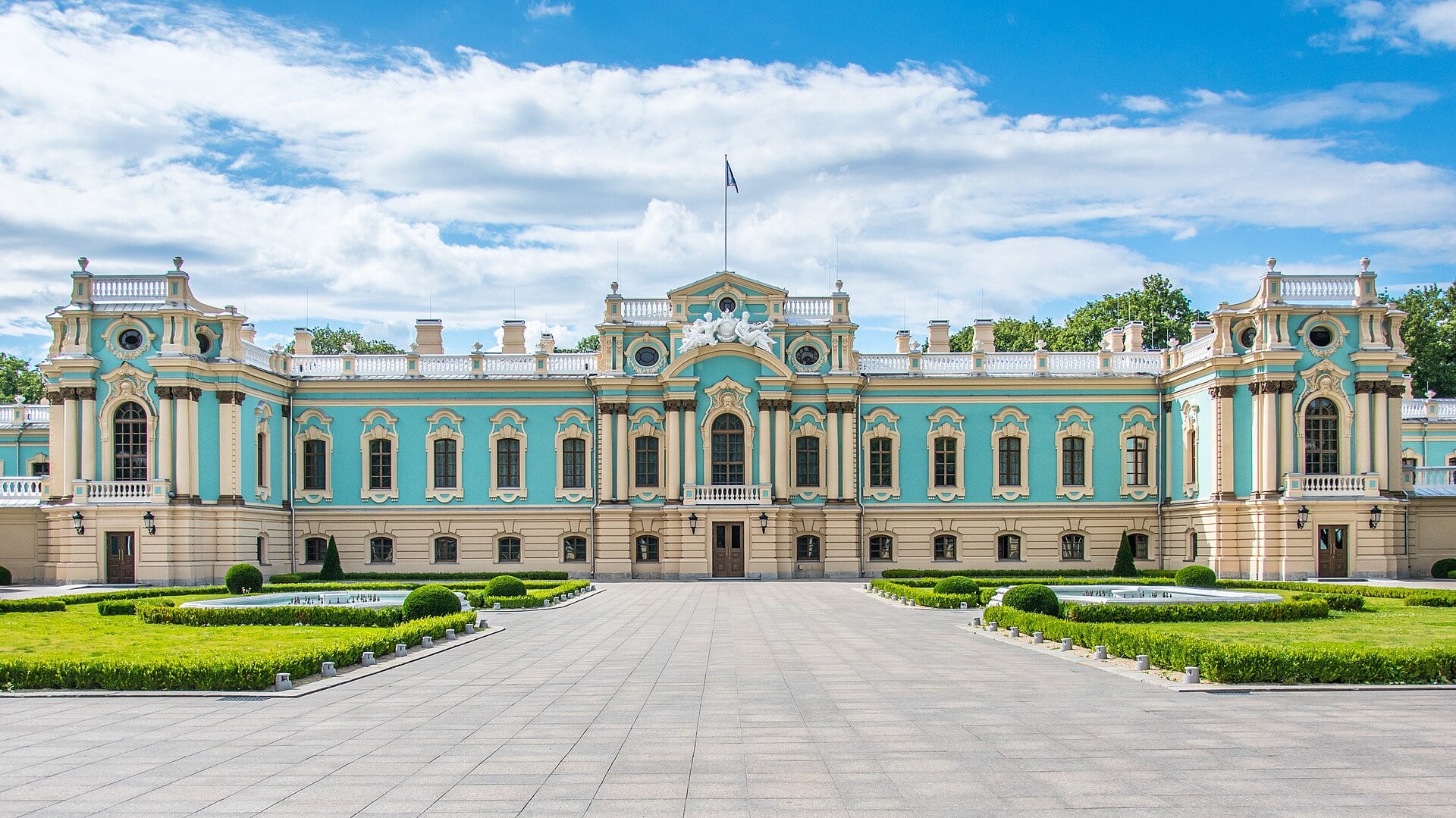 The Mariinskyi Palace in Kyiv, a blue-and-white baroque building with a formal garden in front