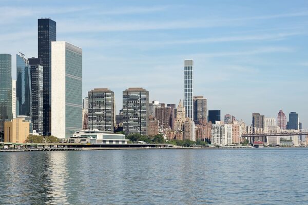 The United Nations headquarters tower on the East River in New York beside the Manhattan skyline