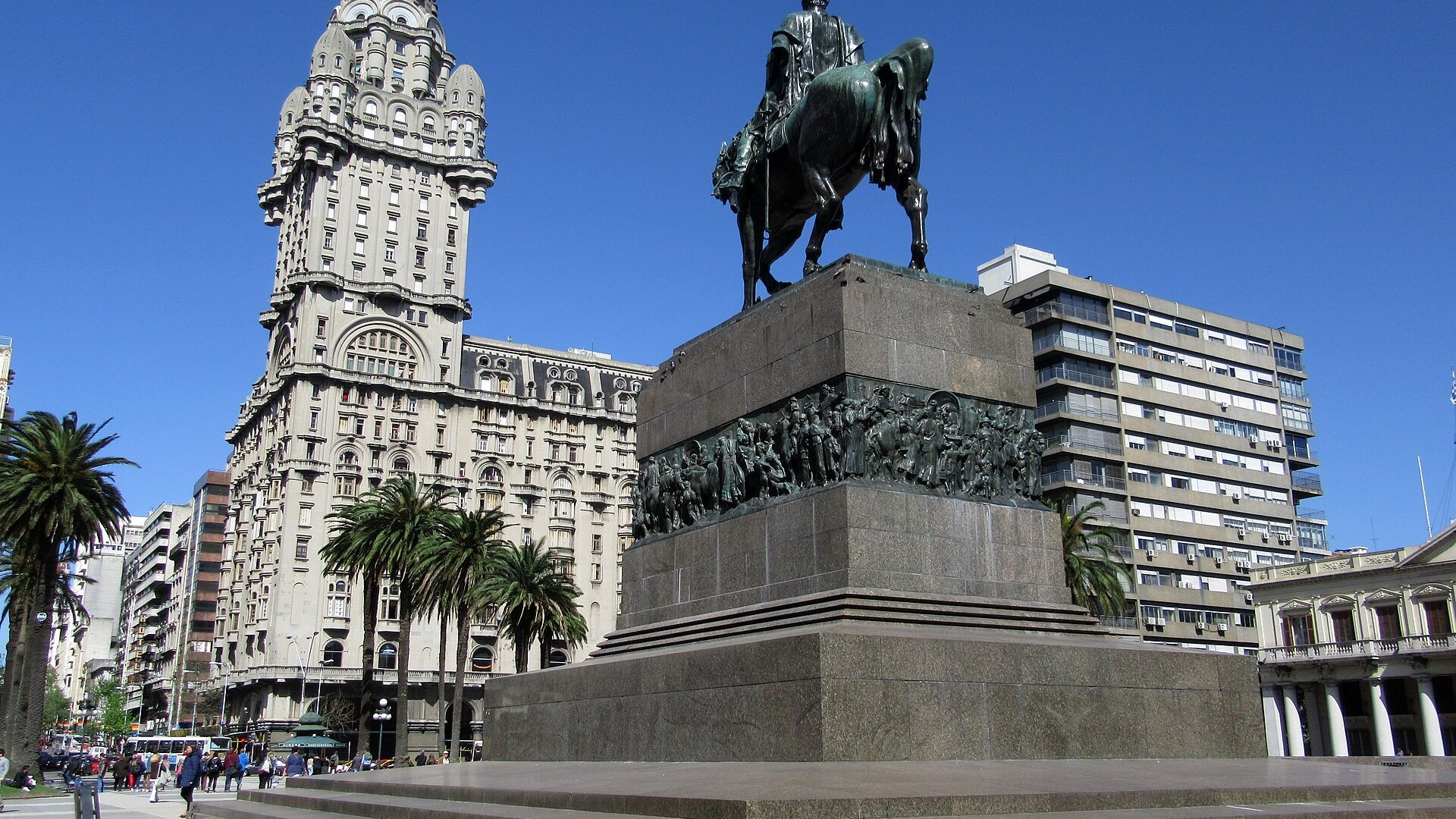 Plaza Independencia in Montevideo with the Palacio Salvo tower and the base of the equestrian statue of Artigas under a blue sky