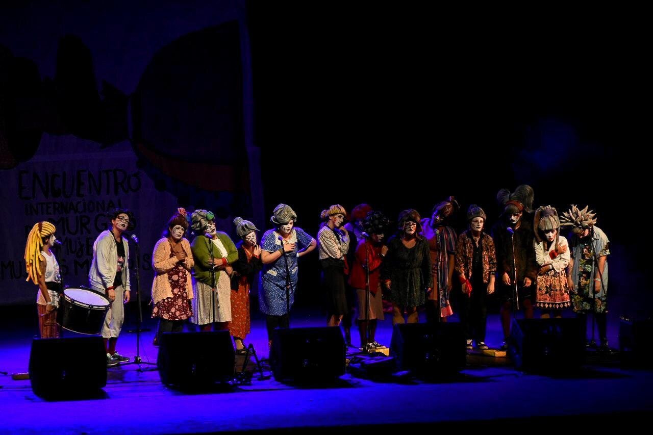 Members of the women's murga Pelalas que van al pan perform on stage at the Teatro de Verano in Montevideo