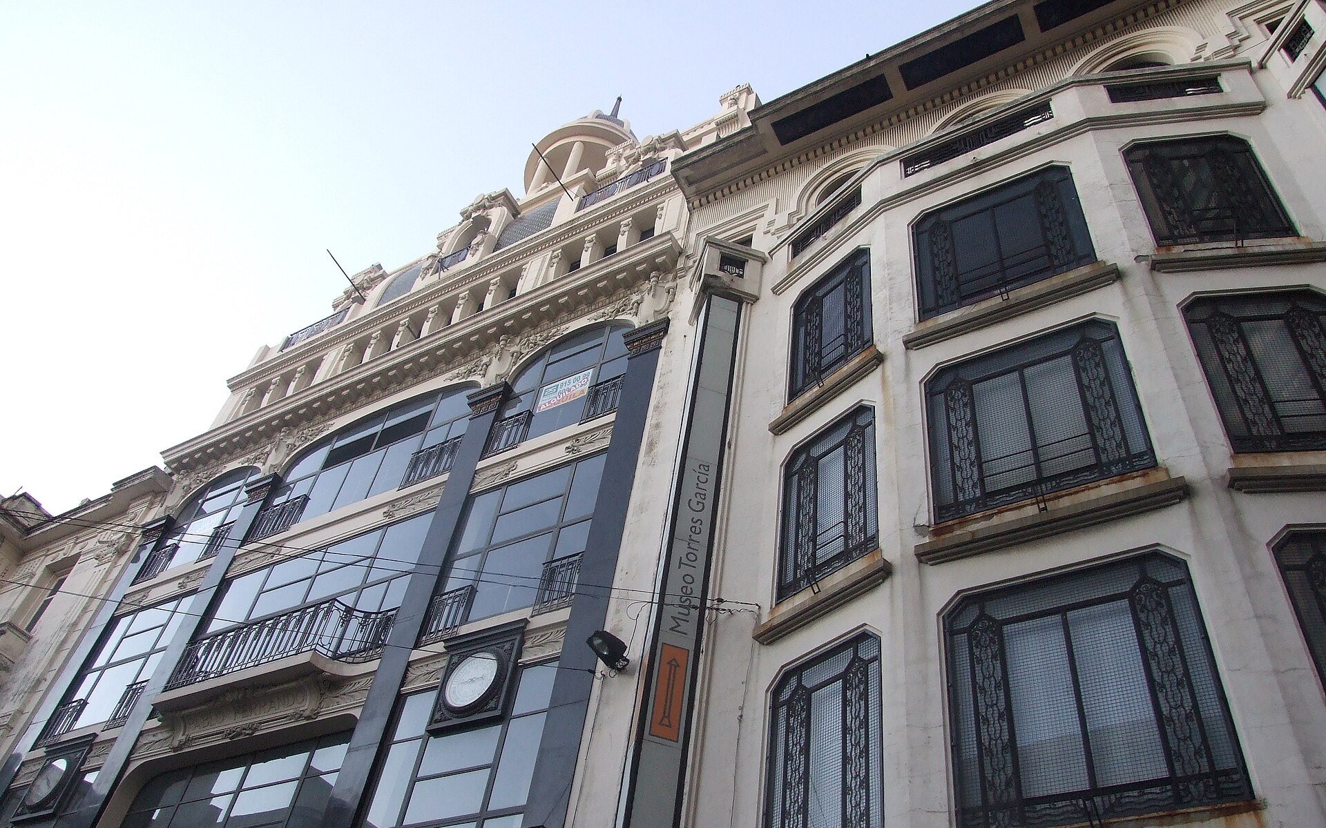 The facade of the Museo Torres García with its vertical museum sign on a street in central Montevideo