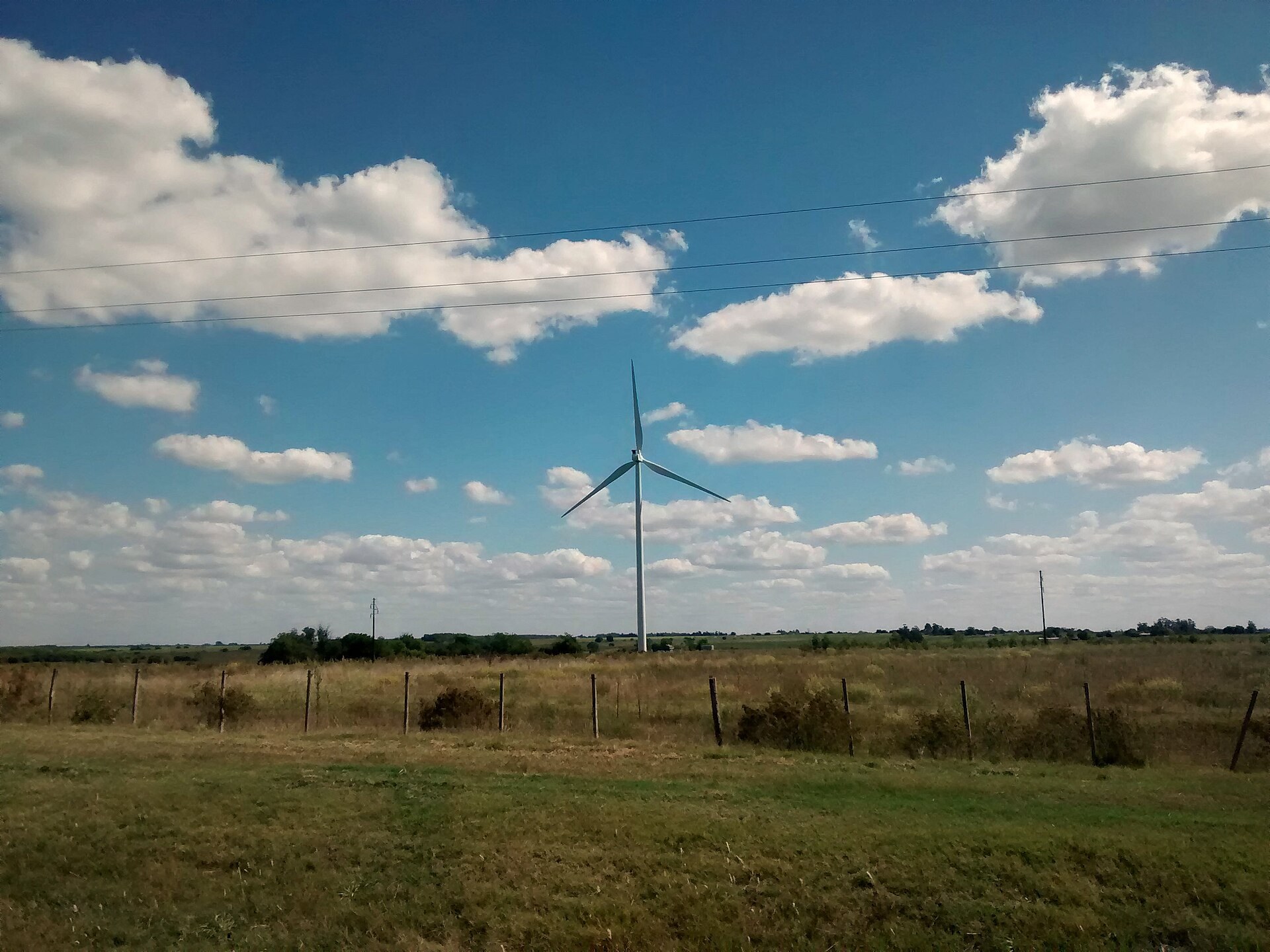 Wind turbine on farmland under a blue sky in the Florida department of Uruguay