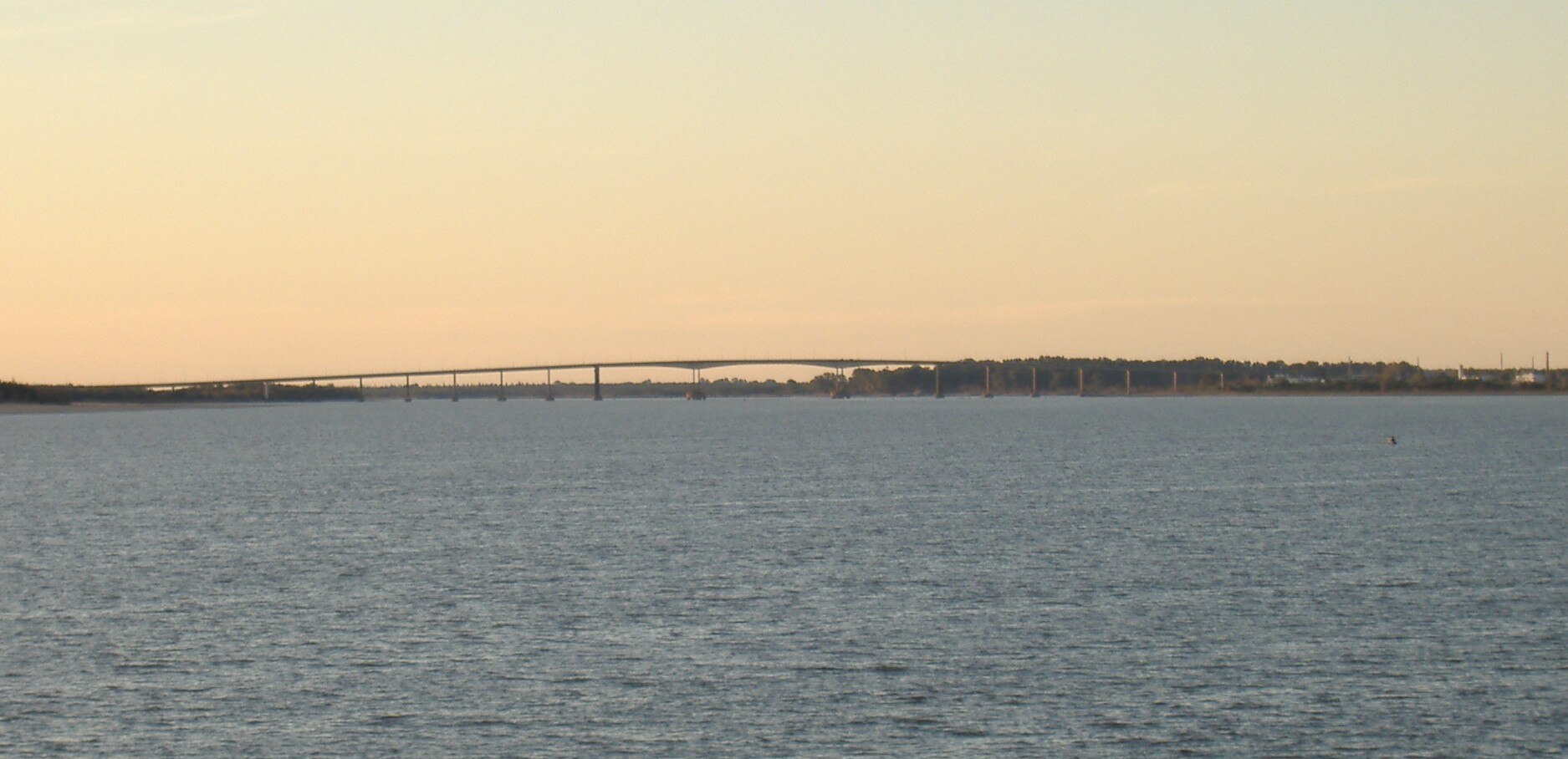 The General Artigas Bridge crossing the Uruguay River from Paysandú, Uruguay, toward Colón, Argentina, at sunset