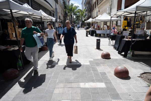 Shoppers walk past market stalls on the Peatonal Sarandi pedestrian street in Montevideo, Uruguay
