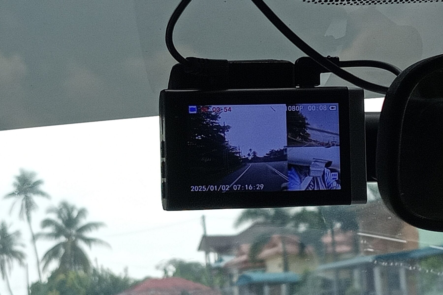 A dashboard camera mounted on a car windshield