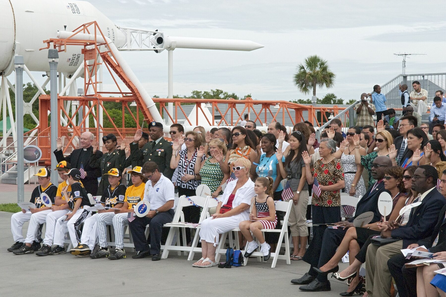 New US citizens raise their right hands to take the Oath of Allegiance at a naturalization ceremony in Florida