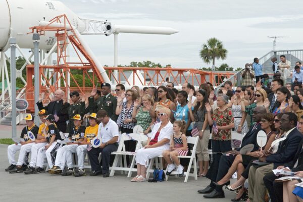 New US citizens raise their right hands to take the Oath of Allegiance at a naturalization ceremony in Florida