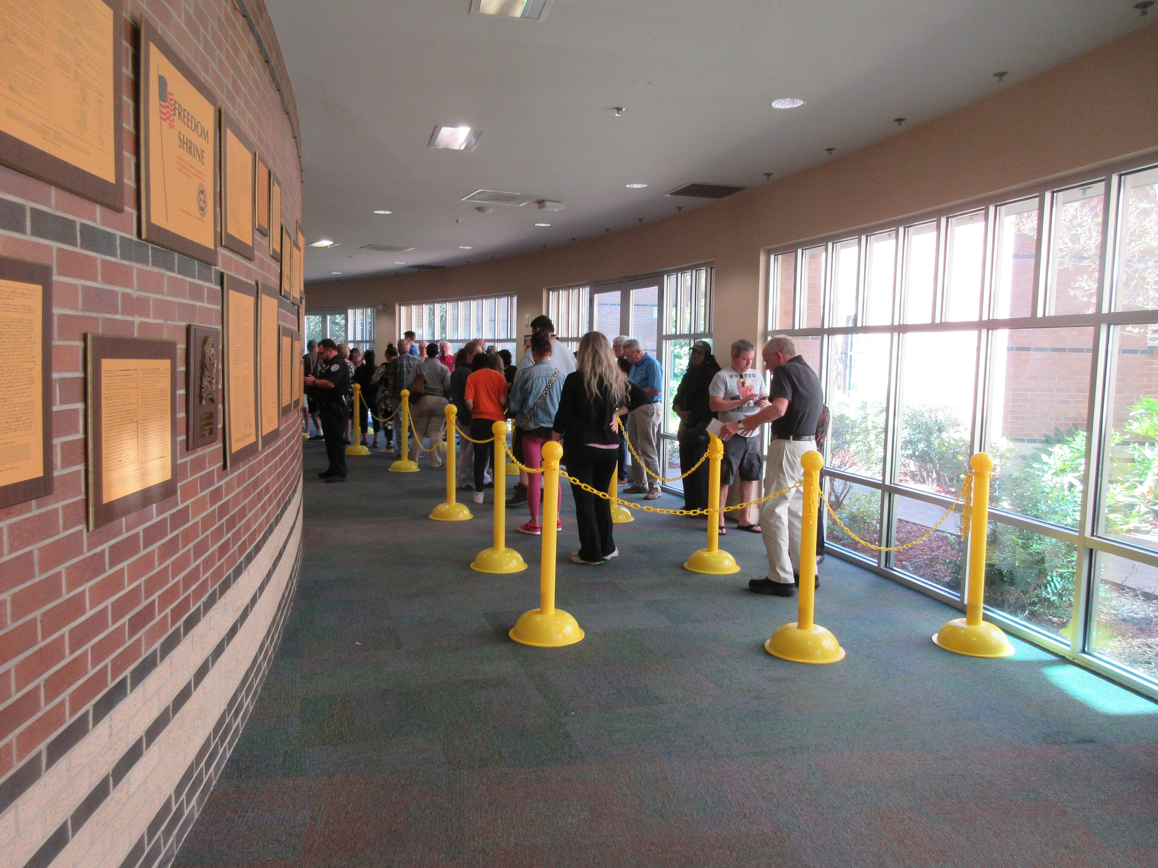 Voters standing in a roped-off line inside a library hallway during early voting in Louisiana