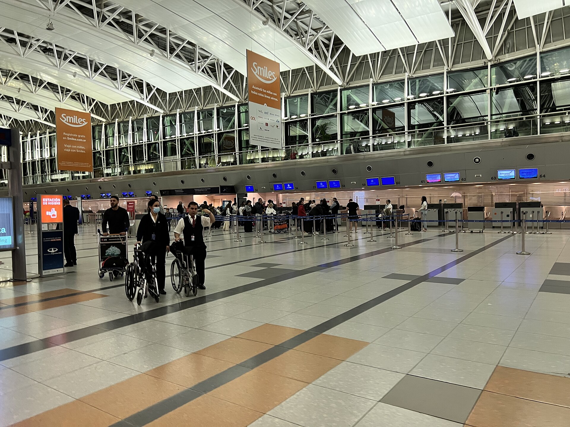 Passengers and check-in counters in the main hall of Ezeiza international airport near Buenos Aires