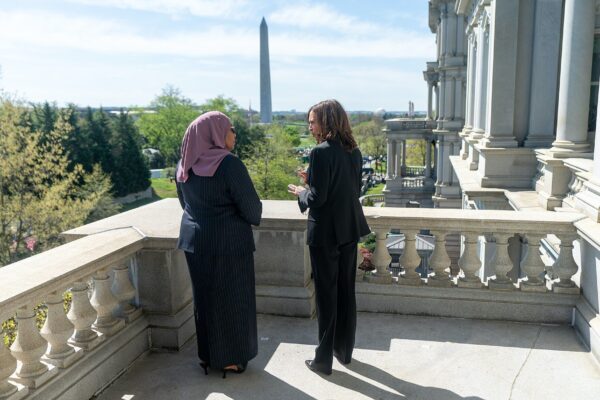 Kamala Harris and Samia Suluhu Hassan talking on a balcony in Washington with the Washington Monument behind them