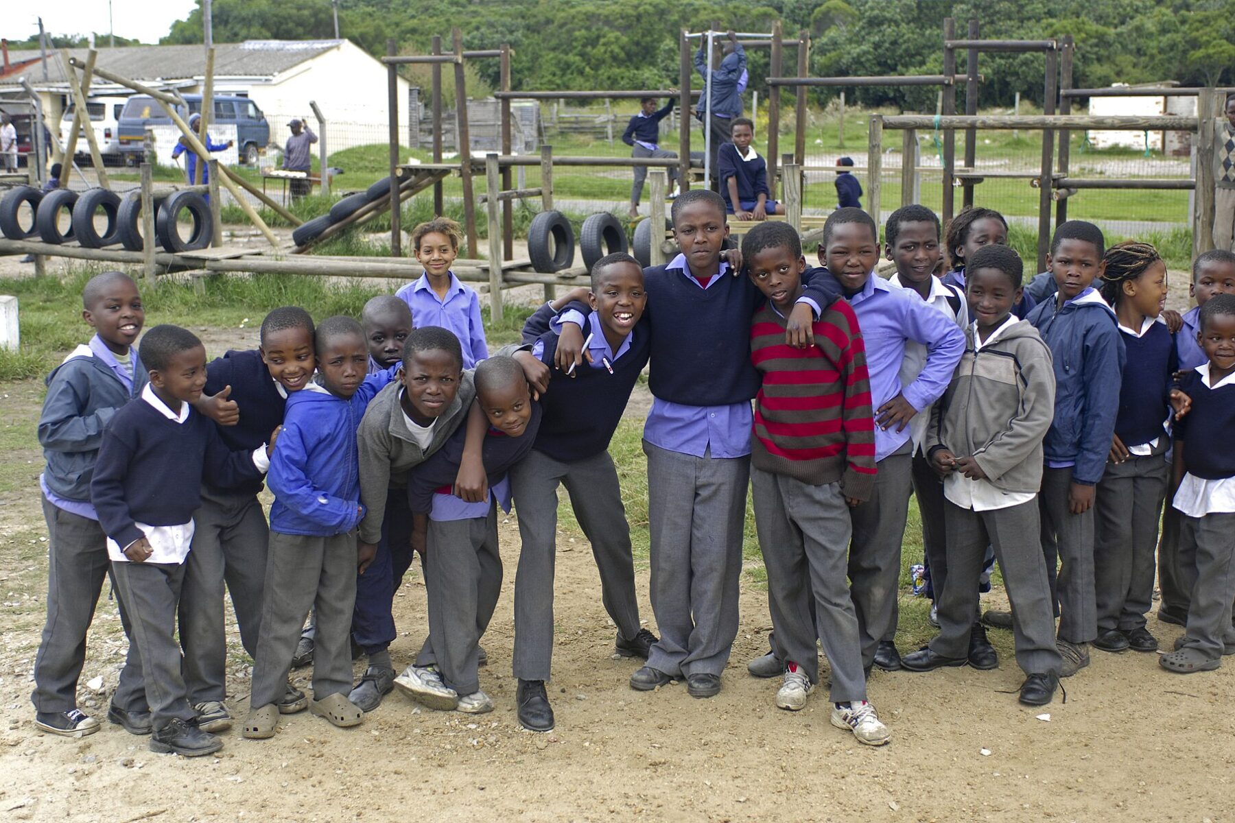 A group of South African pupils in school uniforms standing together on a school playground in Hermanus
