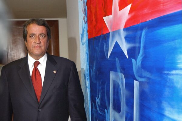 Valdemar Costa Neto, president of Brazil's Liberal Party, standing beside a painted party flag