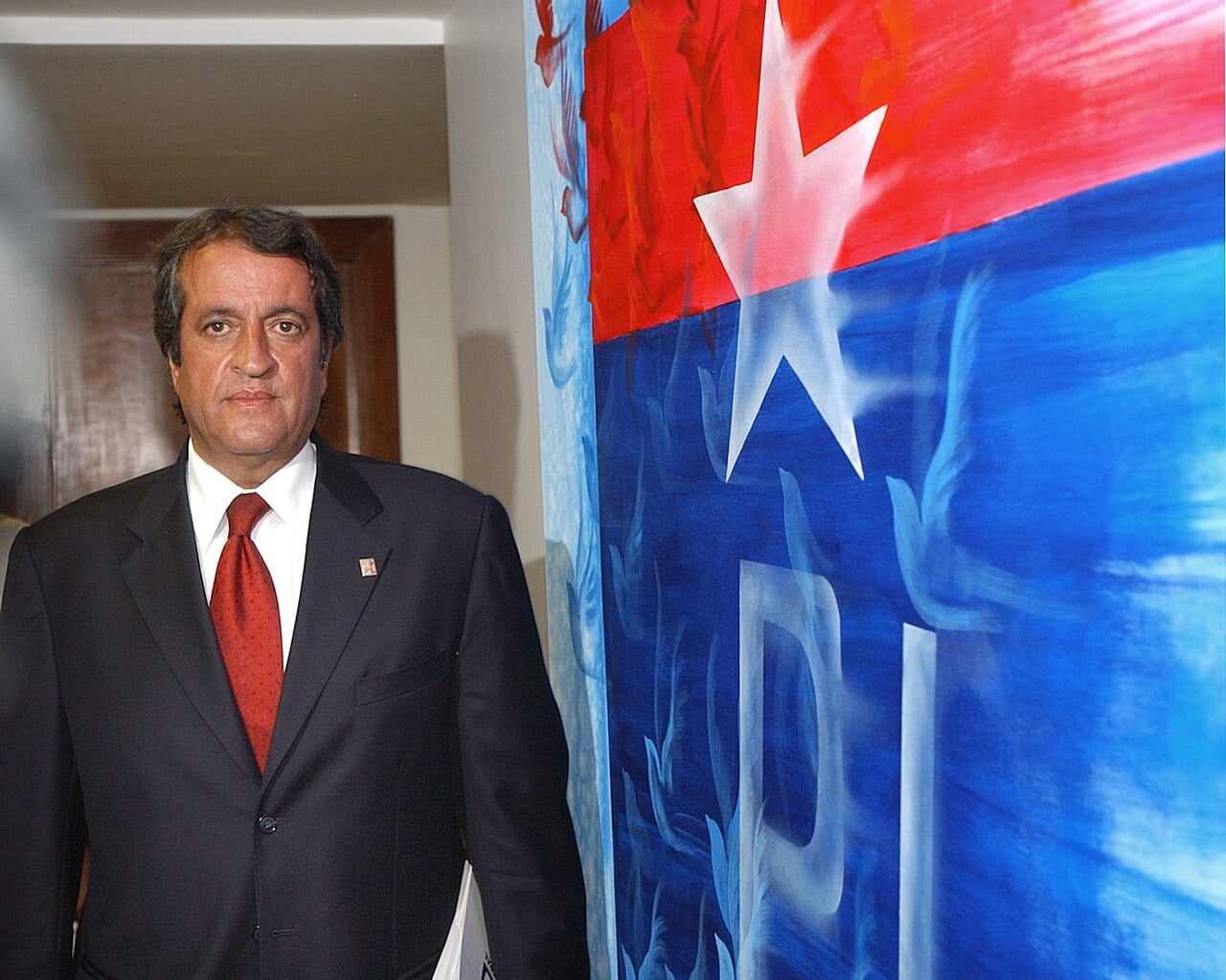 Valdemar Costa Neto, president of Brazil's Liberal Party, standing beside a painted party flag