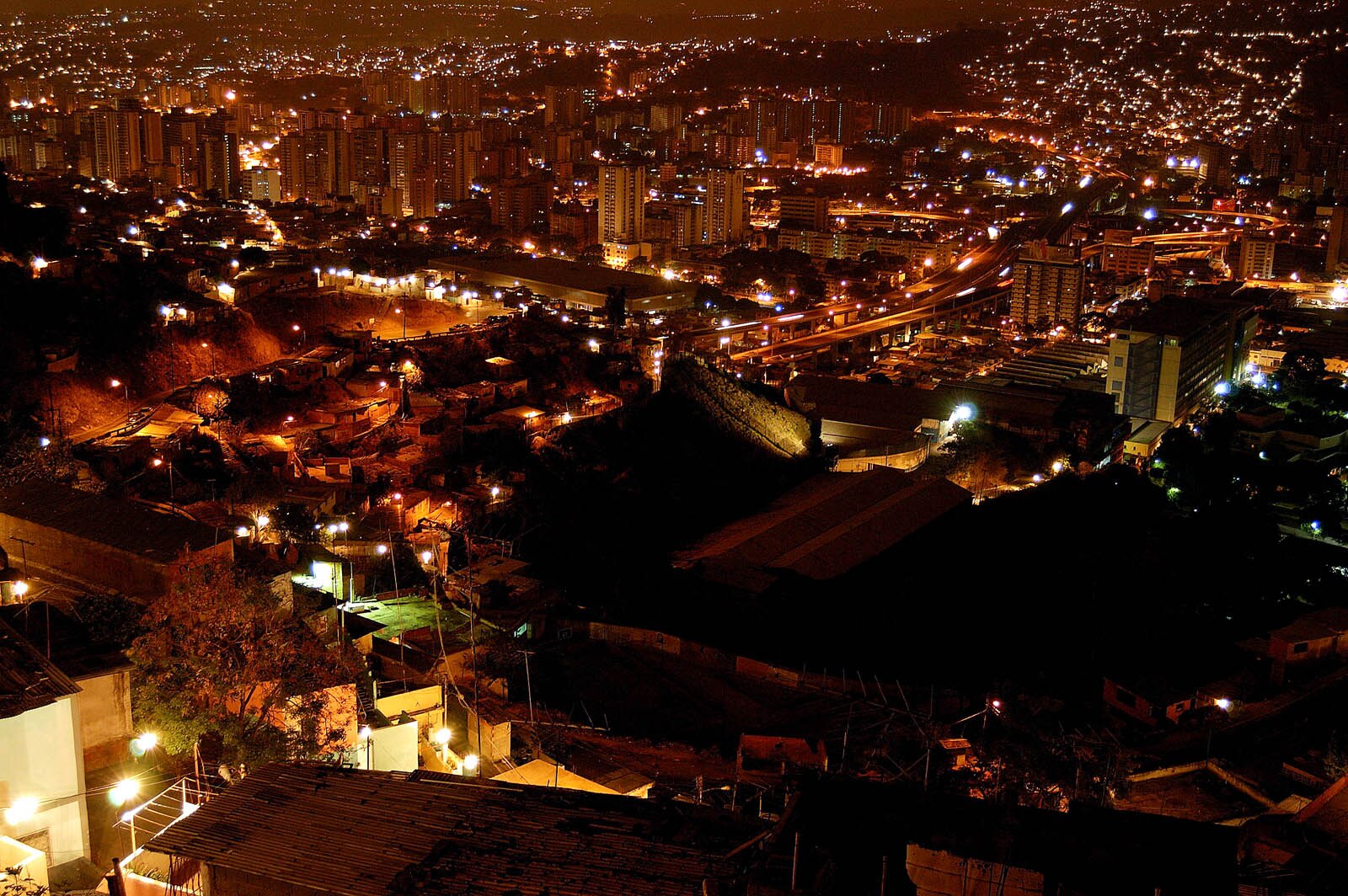 Venezuela geopolitics: Caracas hillside neighbourhoods and the city centre at night