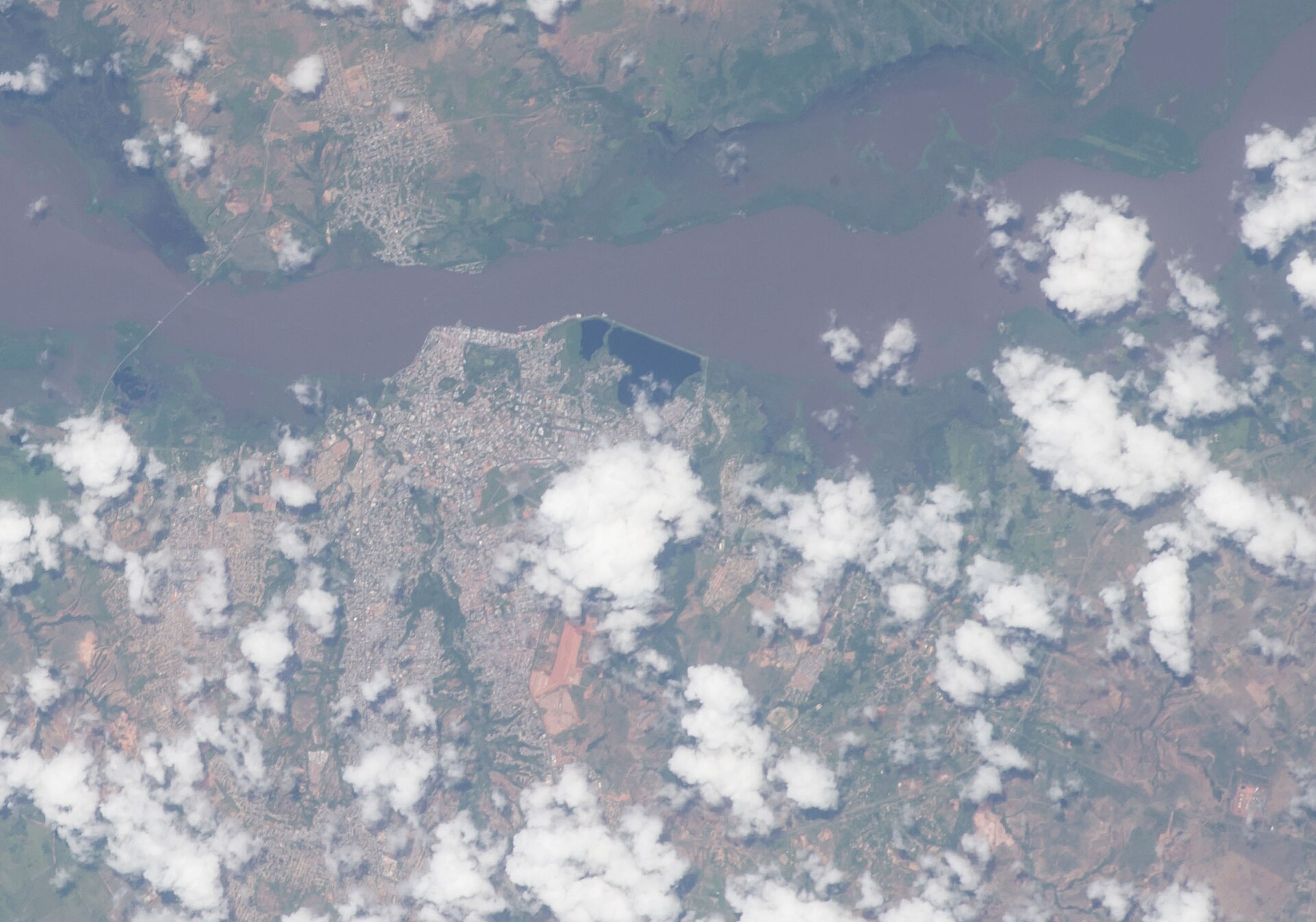 Aerial view from the International Space Station of the wide Orinoco river and Ciudad Bol&iacute;var, Venezuela