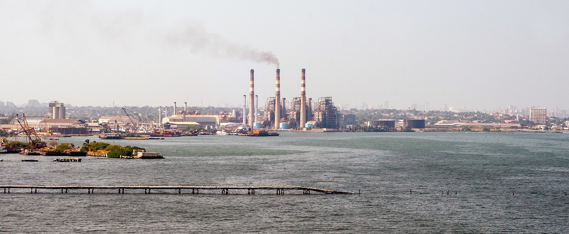 Smoke rises from the three striped chimneys of a thermal power station on the shore of Lake Maracaibo in Zulia state, Venezuela