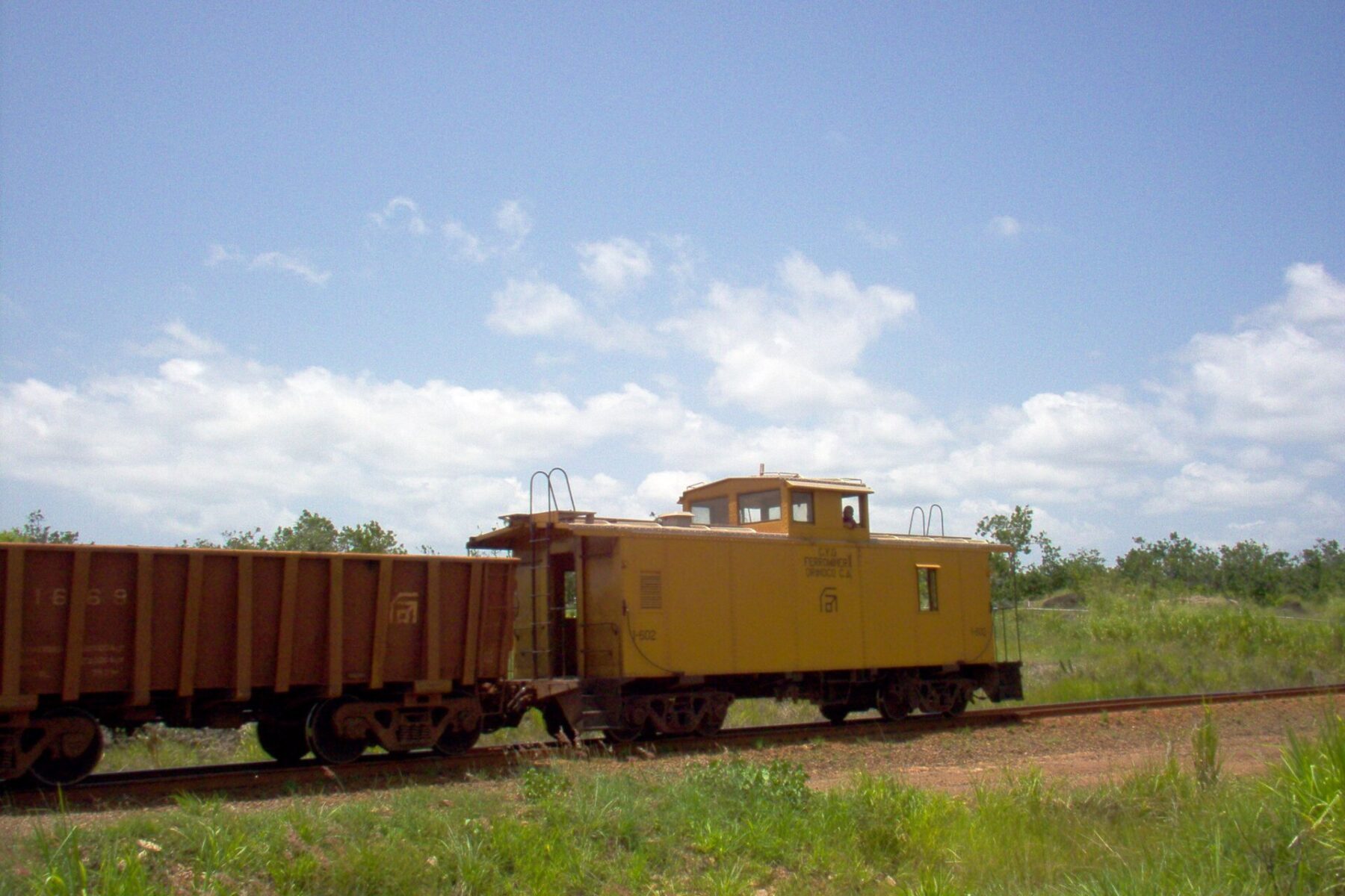 A Ferrominera Orinoco iron-ore train with its caboose on a line in Bolívar state, Venezuela