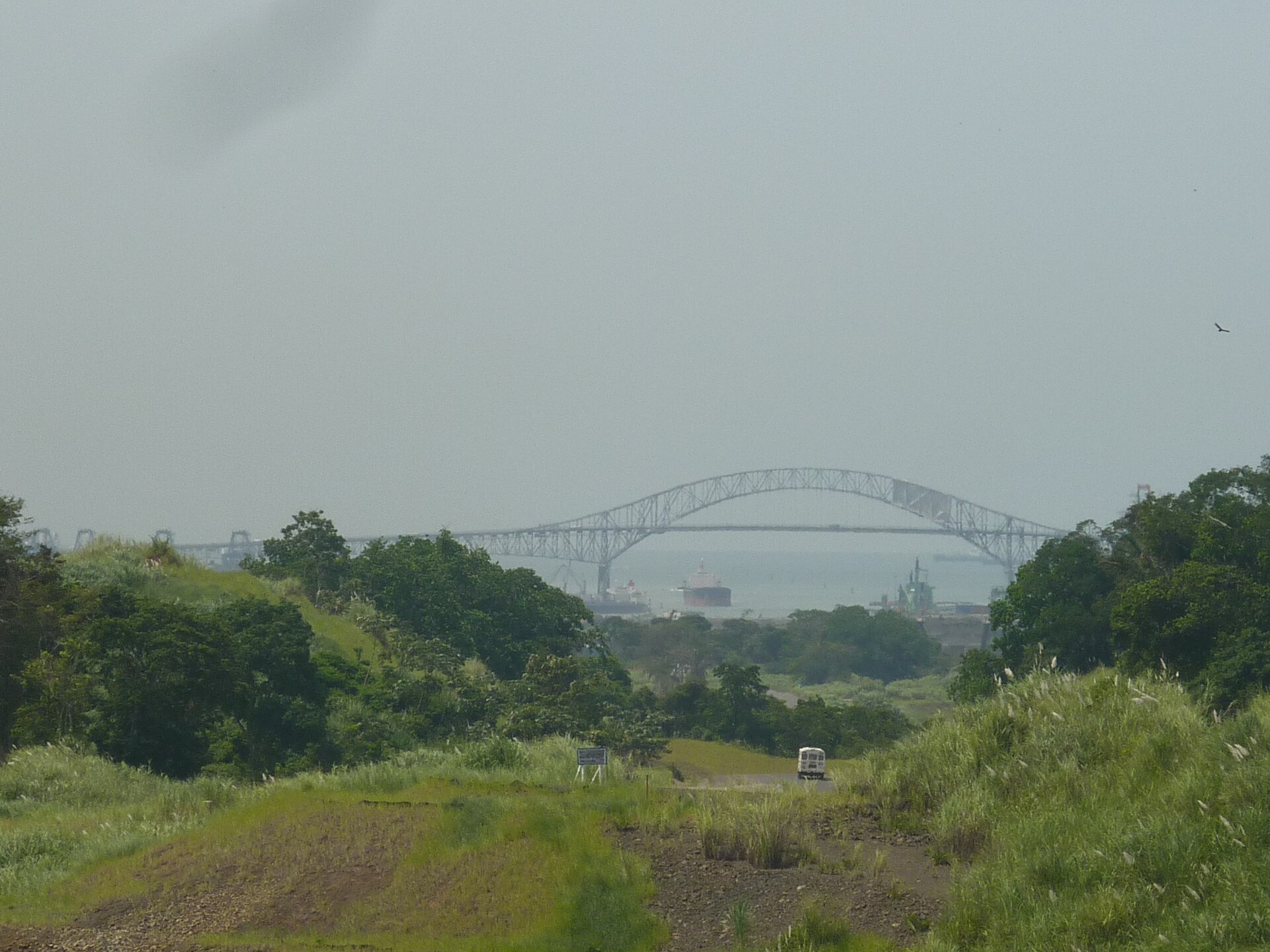 Ships near the Pacific entrance of the Panama Canal with the Bridge of the Americas in the distance