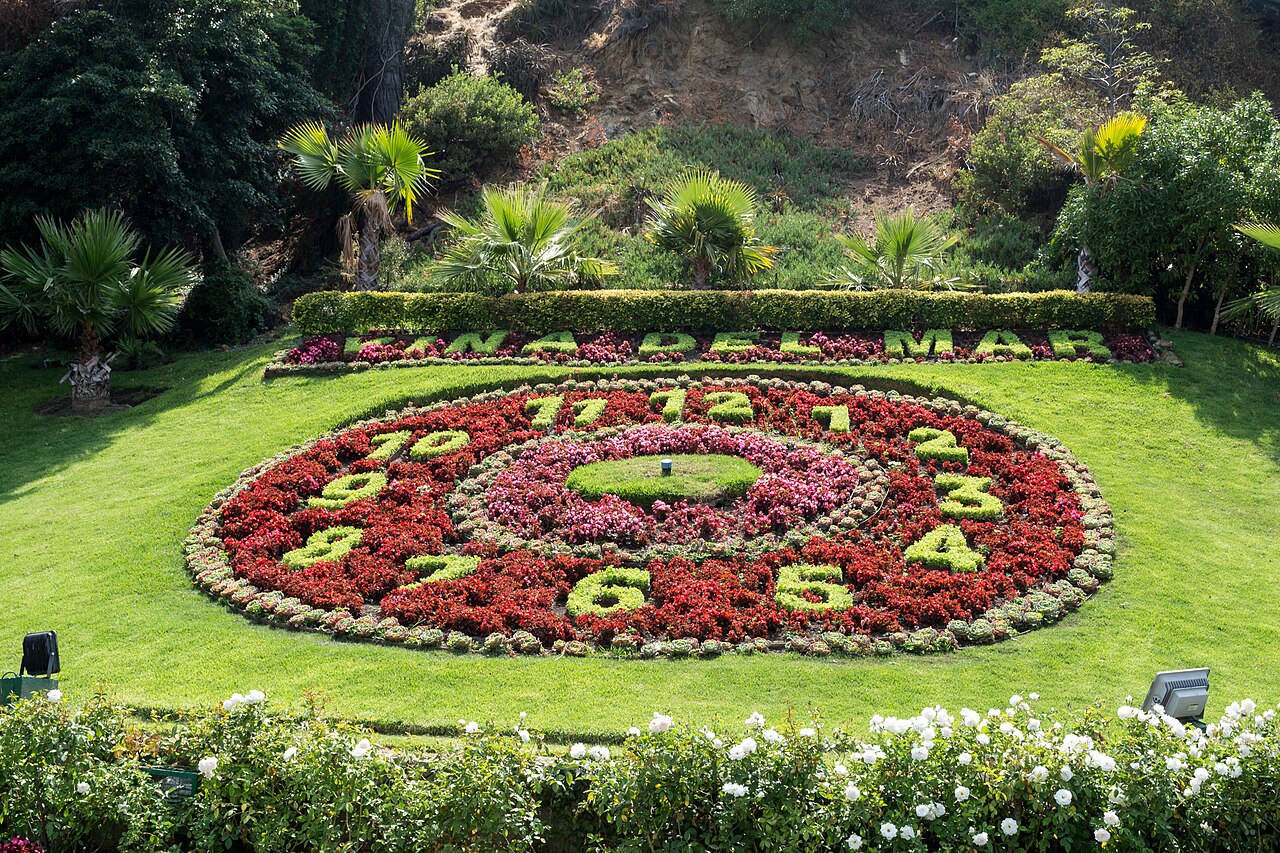 The Reloj de Flores, a flower clock set in a lawn with palms in Viña del Mar, Chile.