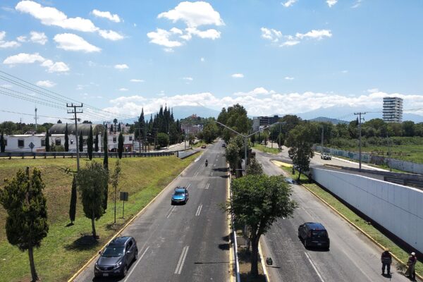The Recta a Cholula highway between Puebla and Cholula in Puebla state, Mexico, with snow-capped mountains on the horizon