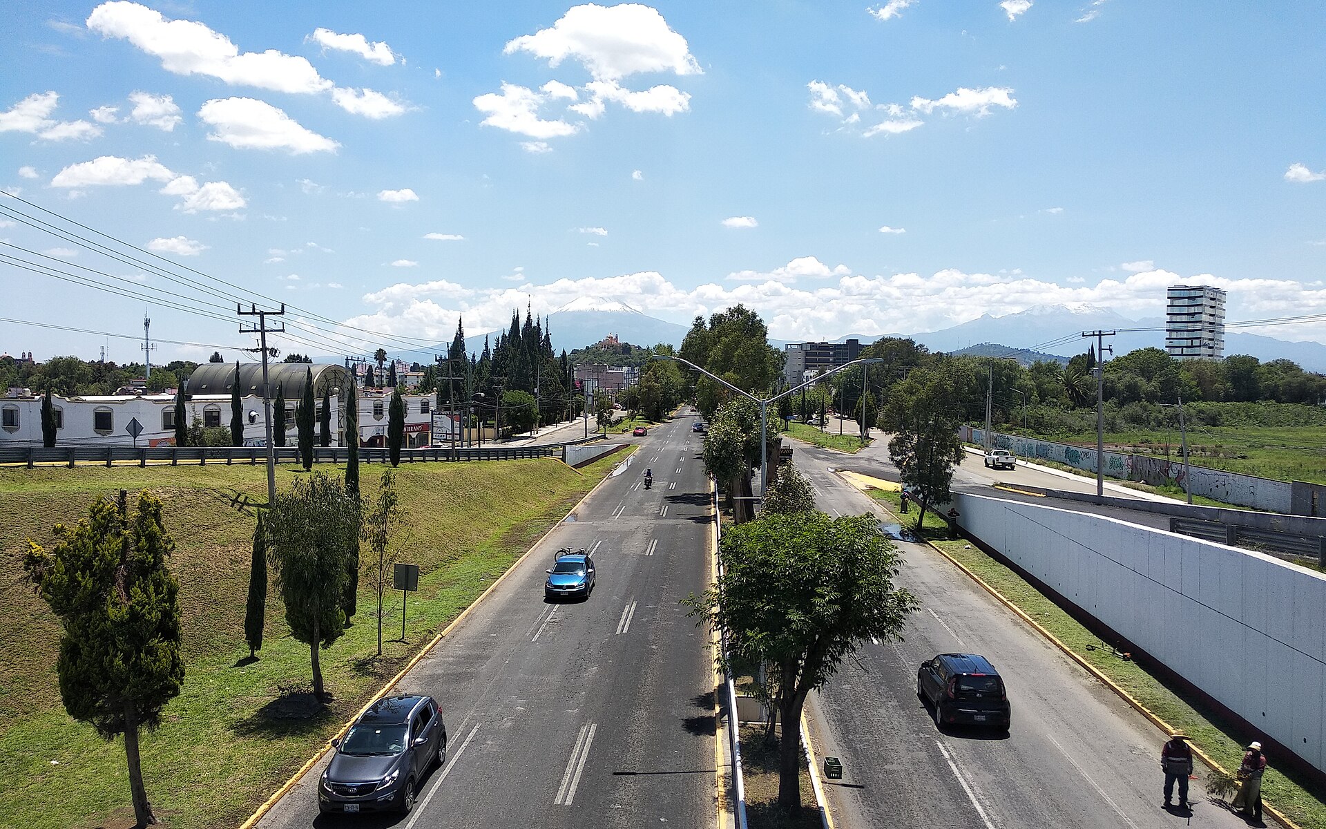The Recta a Cholula highway between Puebla and Cholula in Puebla state, Mexico, with snow-capped mountains on the horizon