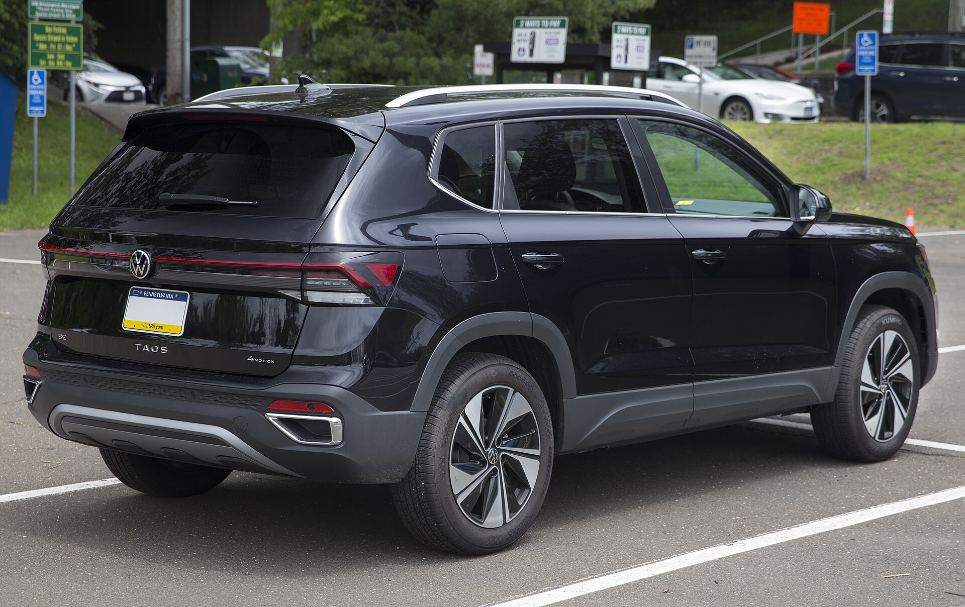 A black Volkswagen Taos 4motion SE compact SUV parked in the United States, a model built in Puebla, Mexico