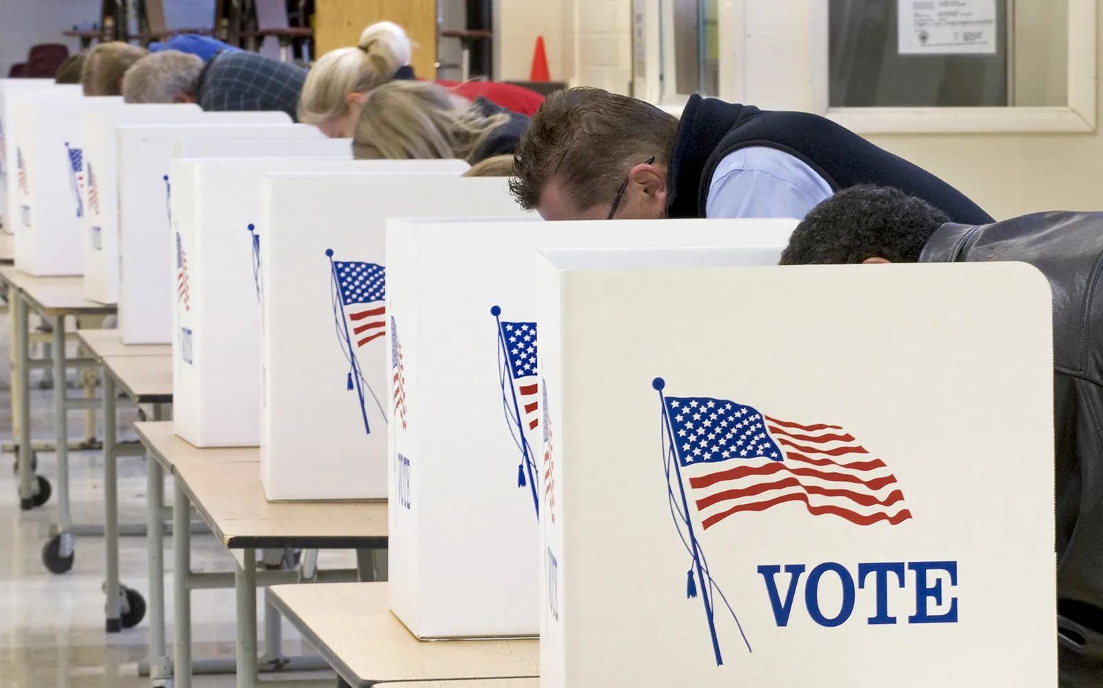 Voters standing in a roped-off line inside a library hallway during early voting in Louisiana