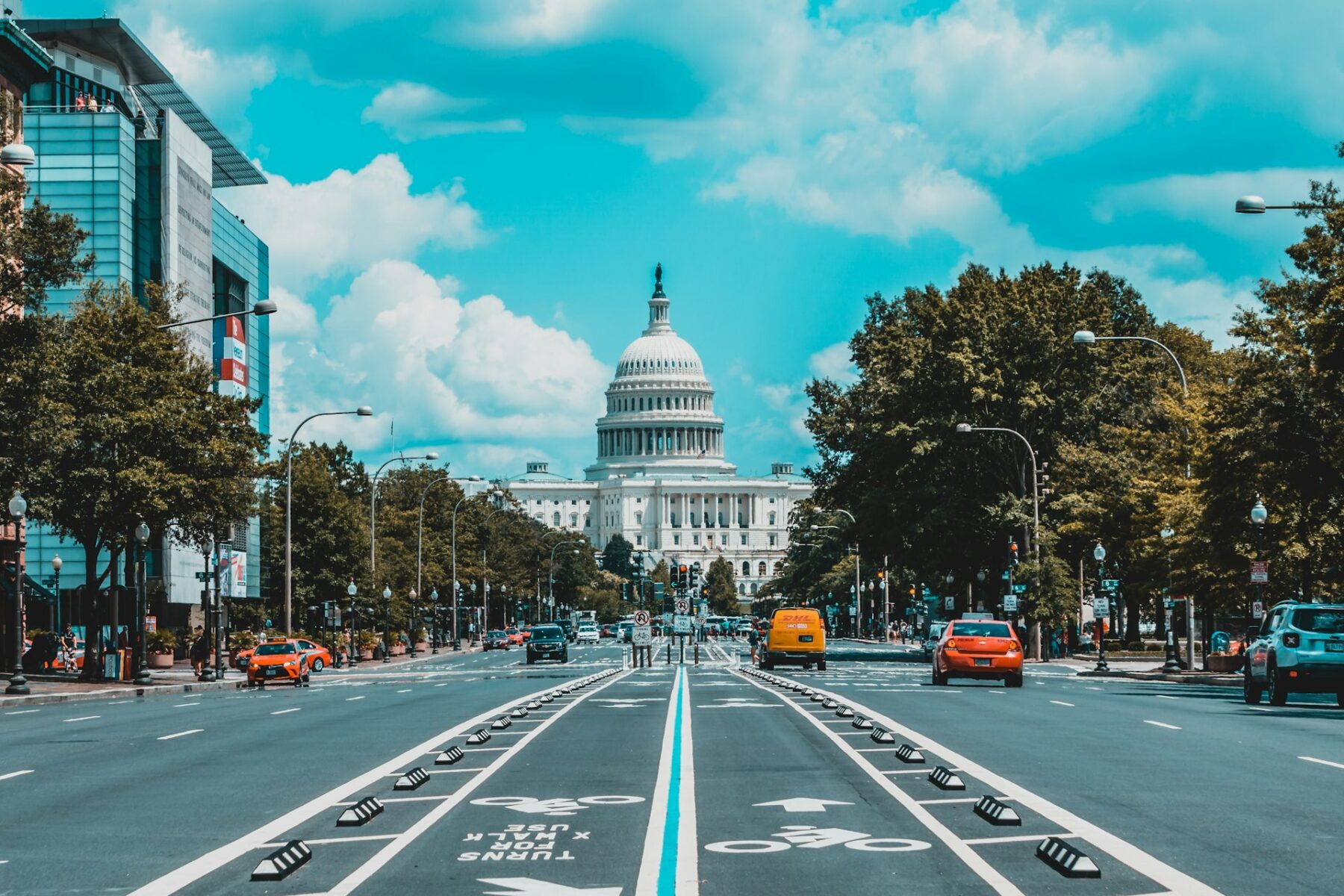 The US Capitol dome seen down Pennsylvania Avenue in Washington, DC, with cars and a bicycle lane