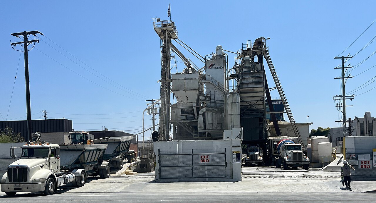 A Cemex concrete batching plant in Hollywood, Los Angeles, with trucks and a mixer lorry in front