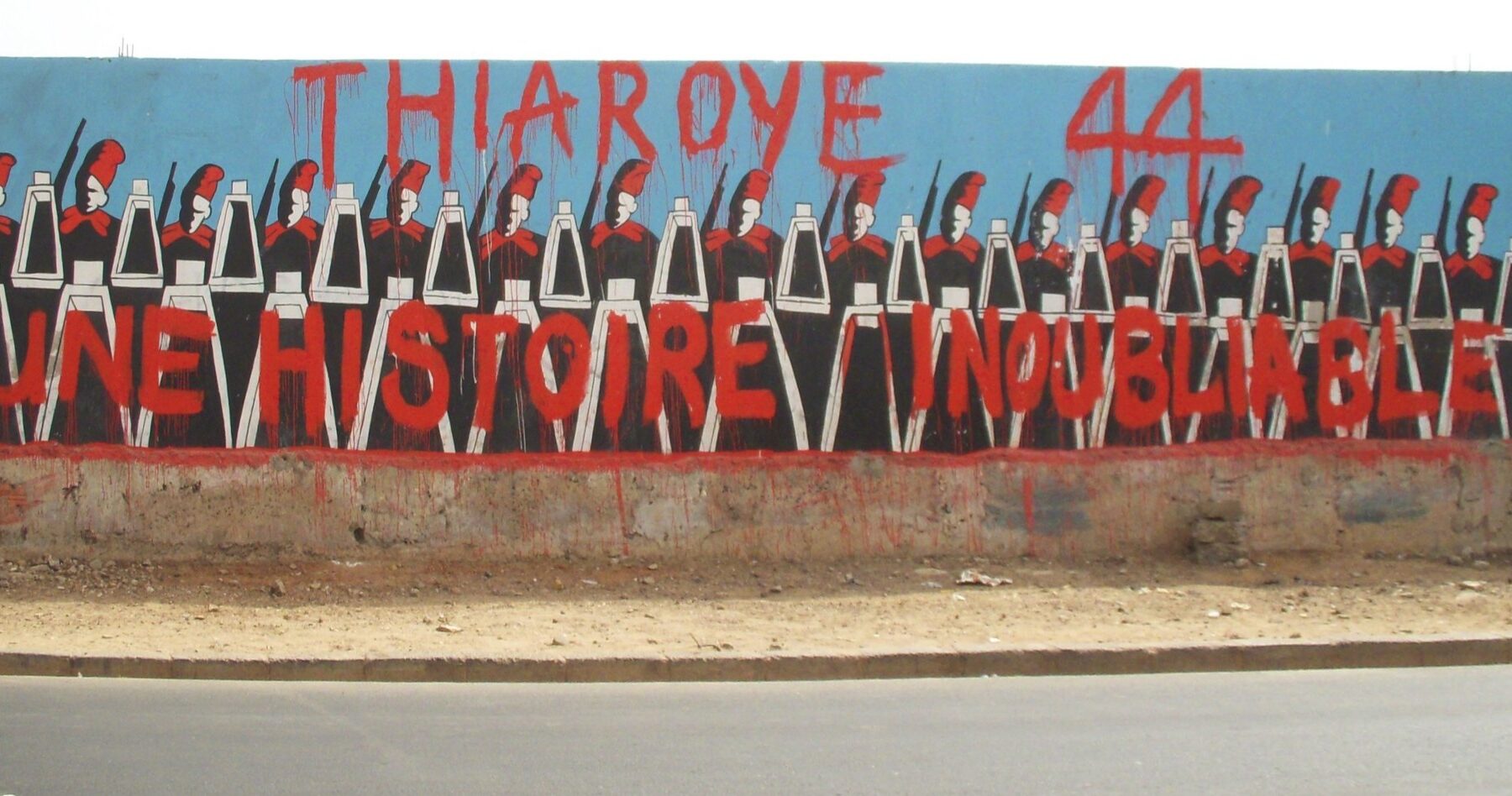 Street mural in Dakar, Senegal, showing rows of colonial-era Senegalese soldiers under the words Thiaroye 44