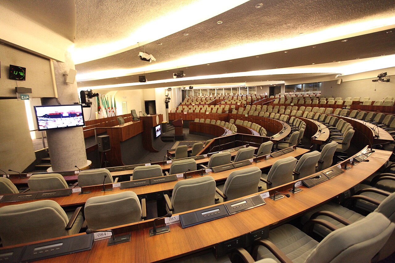 Curved rows of empty seats in the chamber of Algeria's People's National Assembly