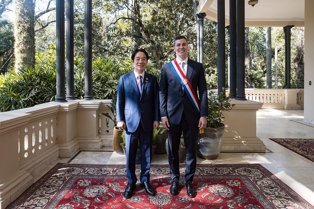 Lai Ching-te and Santiago Peña, wearing a presidential sash, standing together on a palace veranda