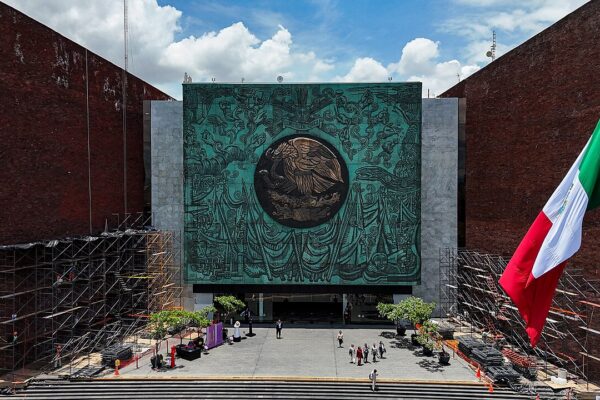 Aerial view of the main entrance of the Legislative Palace of San Lázaro in Mexico City, with the Mexican flag at right