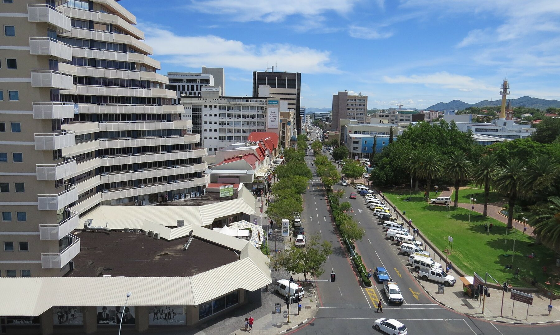 Downtown Windhoek, Namibia, with office buildings, a tree-lined street and a park